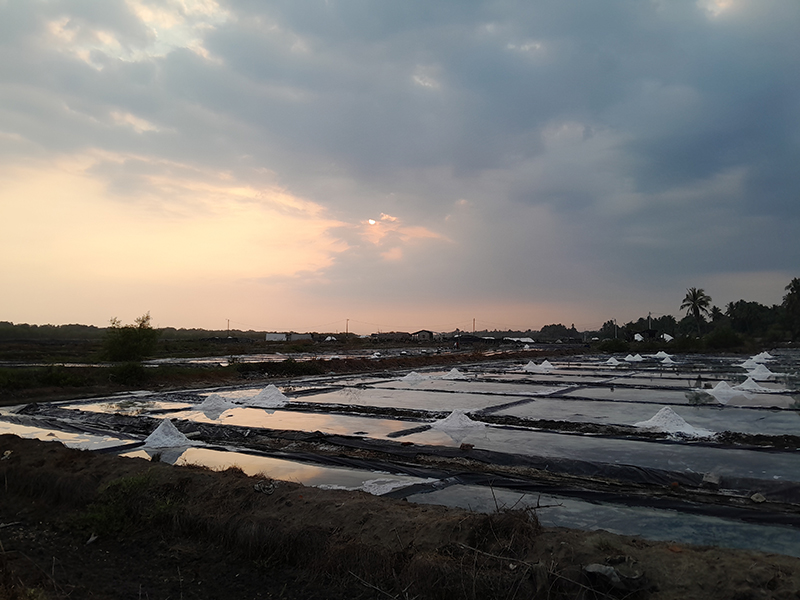 several salt ponds reflecting the sunset in Guatemala